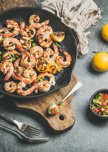 istock Seafood dinner with grilled tiger prawns in pan, grey background 637514888
