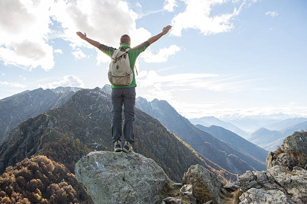 istock Hiker celebrates success on mountain top 637515054