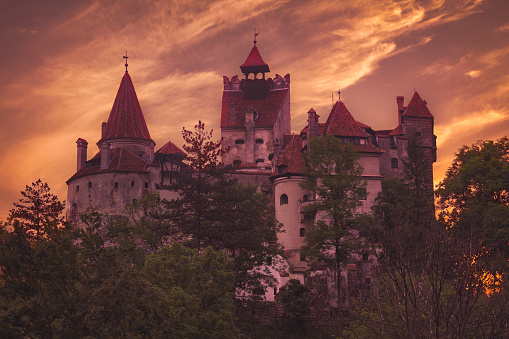 Bran, Romania - June 6, 2016: Sunset at the 14th century Bran castle, famous for the dracula legend. The castle is now a museum and open for tourists.