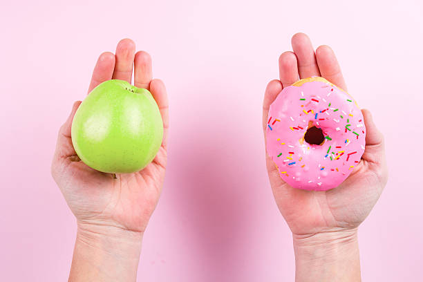 istock Hands choosing between apple and donut as concept of healty 637515898