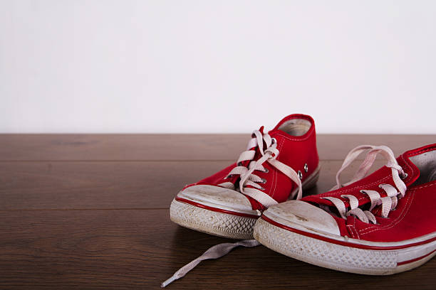 istock Old canvas shoes on a wooden floor 637516932