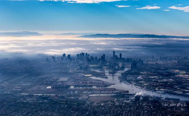 Photo of Melbourne skyline with skyscrapers emerging from the morning fog