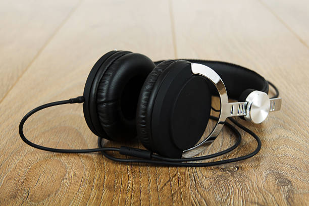 istock Pair of headphones on a rustic wooden surface 637518574