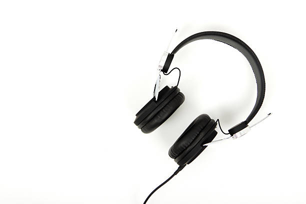 istock Black headphones against a light coloured background 637518586