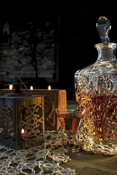 istock Engraved bottle with whisky, glass and candle 637521010