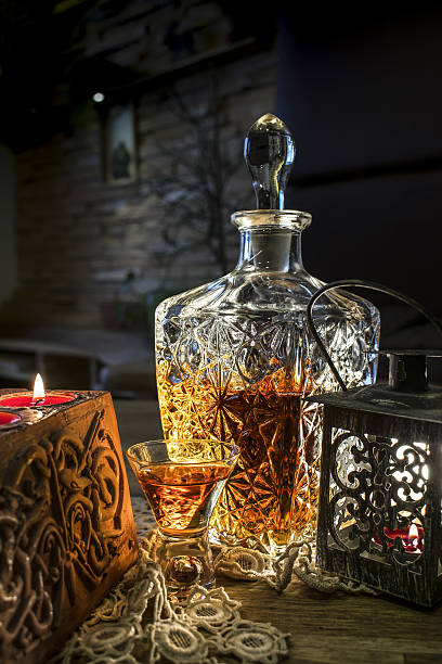 istock Engraved bottle with whisky, glass and candle 637521562