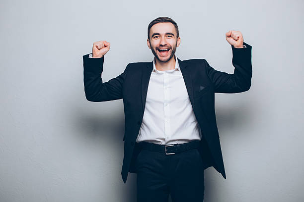 istock Young businessman in suit raised hands isolated 637521704