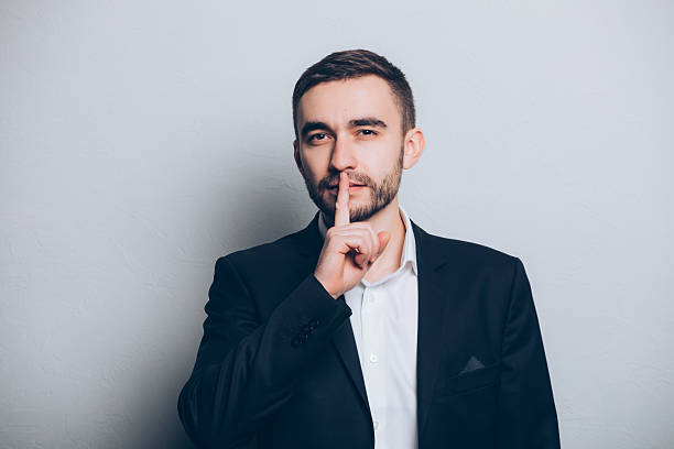 istock Young businessman in suit silence gesture isolated 637521810