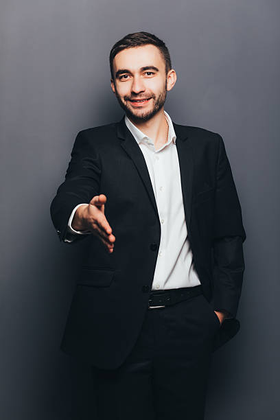 istock Young businessman in suit give hand shake  isolated 637522306