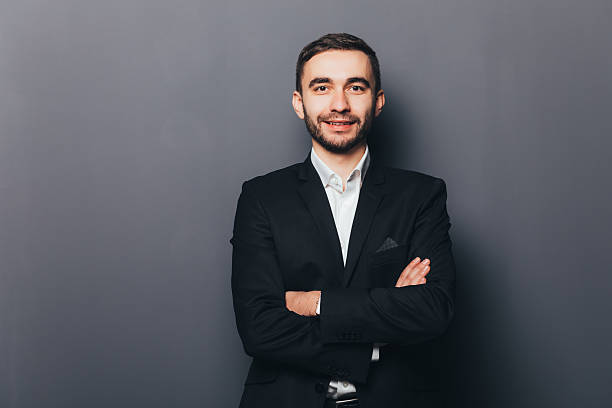 istock Young businessman in suit with crossed hands isolated 637522576