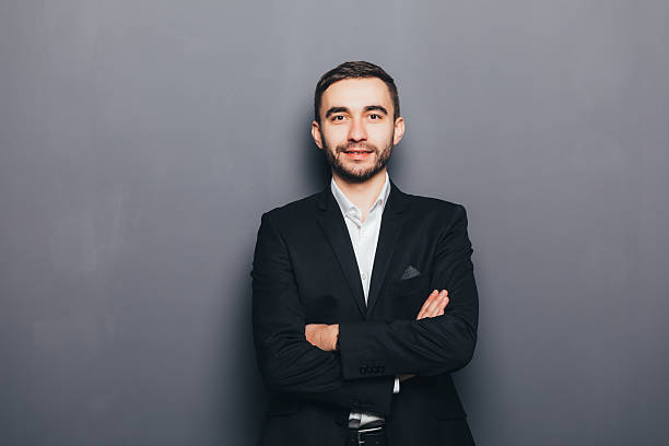 istock Young businessman in suit with crossed hands isolated 637522632