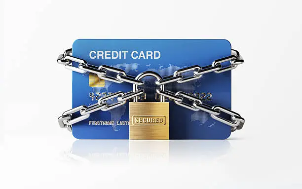 A blue credit card  chained with padlock. There is security stamp on padlock. Horizontal composition with copy space. Front view. Great use for e-commerce, online shopping and security related cocepts. Clipping path is included. Isolated on white background.