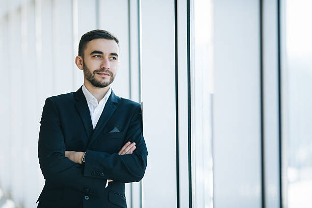 istock Handsome businessman in suit in office 637525796