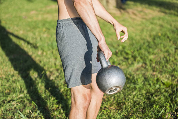istock Closeup of man holding heavy kettlebell 637527398