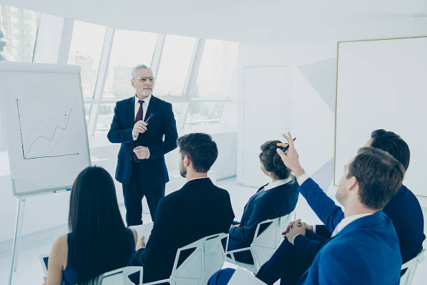 istock Senior partner making  presentation on whiteboard in the office 637527514