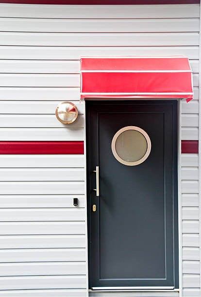 Red theme perennial garden in front yard with glass door.