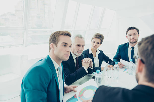 istock Portrait of serious business people discussing  new project 637529310