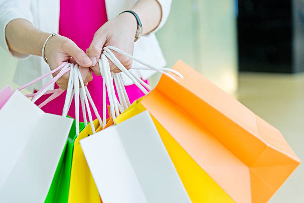 istock Woman holding shopping bags 637532394