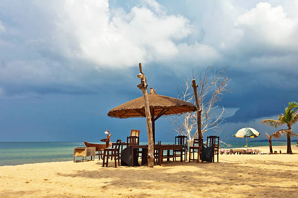 istock Wooden chairs and umbrellas on white sand beach 637532532