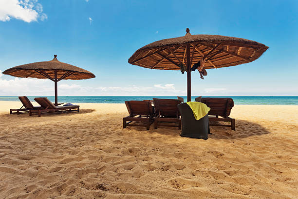 istock Wooden chairs and umbrellas on white sand beach 637532556