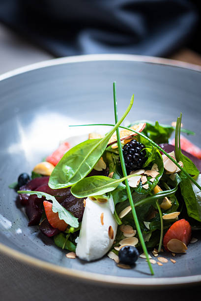 istock Salad leaves with goat cheese cream 637534558