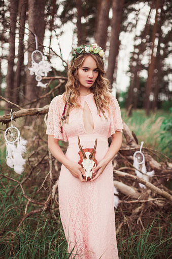 Woman with whitetail deer skull and antlers