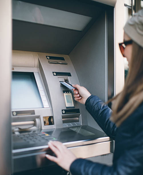 istock Young woman taking money from ATM 637535548