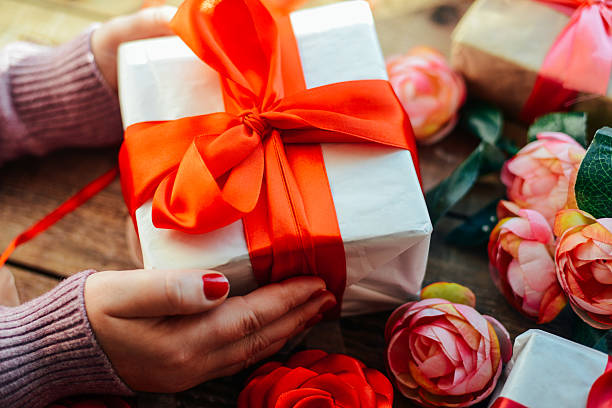 istock Valentine's Day concept. Gift with red bow  on the wooden 637535874