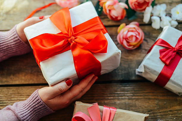 istock Valentine's Day concept. Gift with red bow  on the wooden 637537076