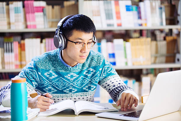 istock young asian man with headset in library 637538128