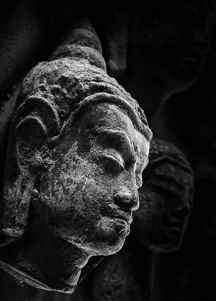 istock Closeup of the buddha face with light and shadow 637540302