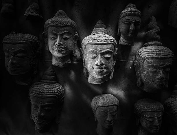 Closeup of the buddha face with light and shadowin black and white.
