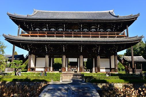 Kyoto, Japan-December 3, 2016: The photo shows Sammon Gate (Main Gate) of Tofuku-ji Temple, which is designated as Japan’s National Treasure and is the largest and oldest Zen temple gate in Japan. Sammon is short for Sangedatsumon, which means an enlightment gate to Nirvana (i.e. a high spiritual state of freedom from all suffering).
