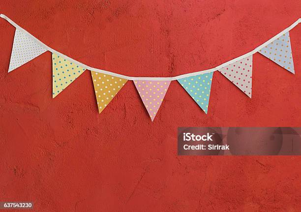 Color Party Flags On Red Cement Wall Stock Photo - Download Image Now - Pennant, Wall - Building Feature, Anniversary