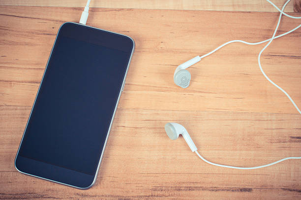 istock Mobile phone with headphones 637545454