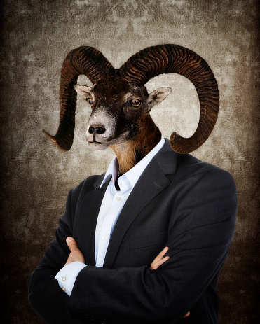 Head of a Goat on a man's body on textured brown background
