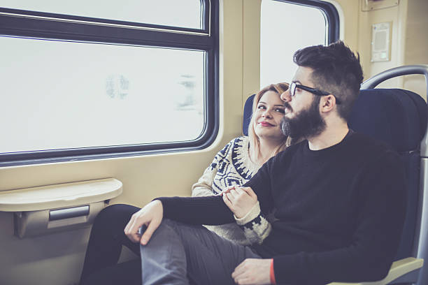istock Happy couple traveling by train 637554580