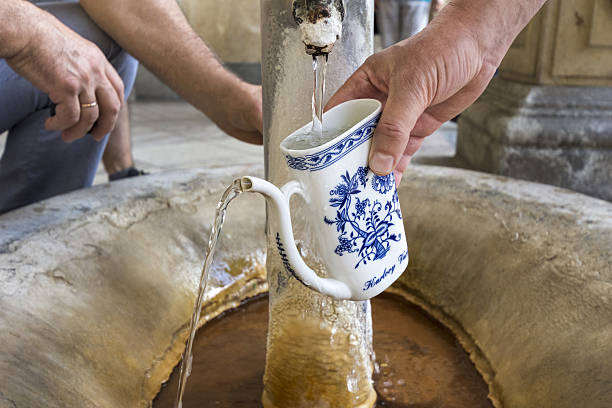 A cup filled with fresh mineral water from a geothermal spring in the spa town of Karlovy Vary, in the Czech Republic. The water is thought to have many healing, medicinal qualities. 
