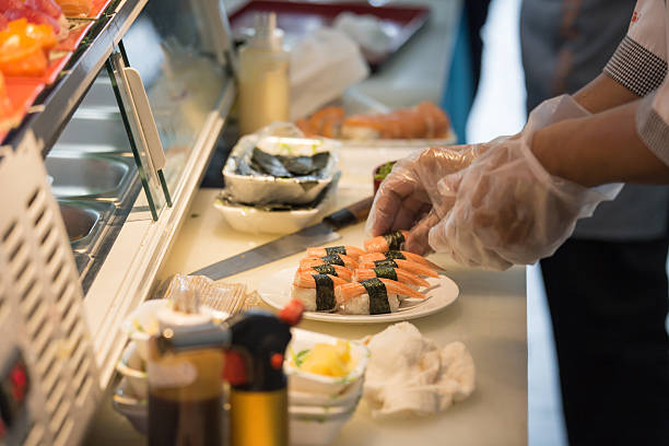 istock chef hand in glove cooking seaweed sushi 637559772