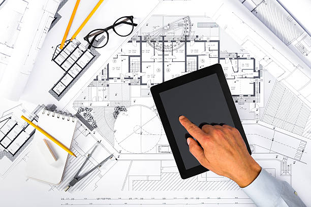 construction plans and male hands using a tablet on blueprints - instrument of measurement organization housing project housing development imagens e fotografias de stock