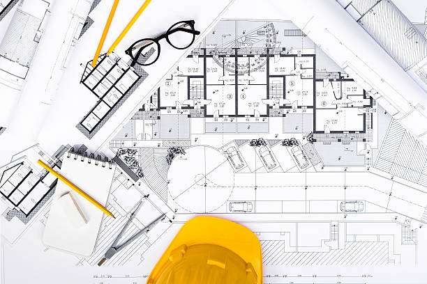 Construction plans with Tablet, drawing and working Tools on blu stock photo