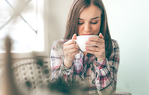 Young woman tasteing a coffee
