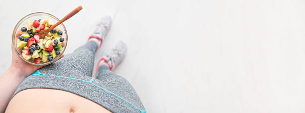 istock Woman is eating a healthy fruit salad after a workout. 637567596