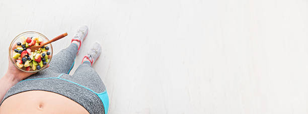 istock Woman is eating a healthy fruit salad after a workout. 637567648