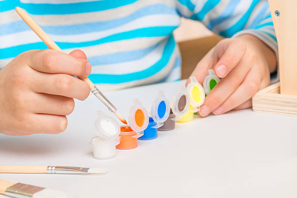 istock boy 6 years old with a brush and paints 637570536