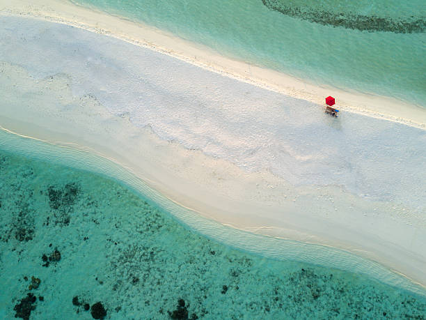 aerial lonely red umbrella beach maldives süd ari atoll - beach ideas stock-fotos und bilder