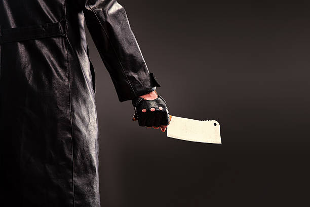 istock Killer holding meat cleaver in hand. 637572354