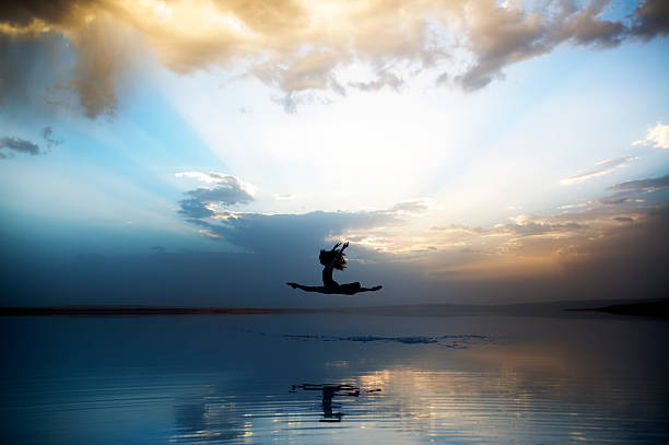 istock Ballerina jumping and dancing in the sky 637572764