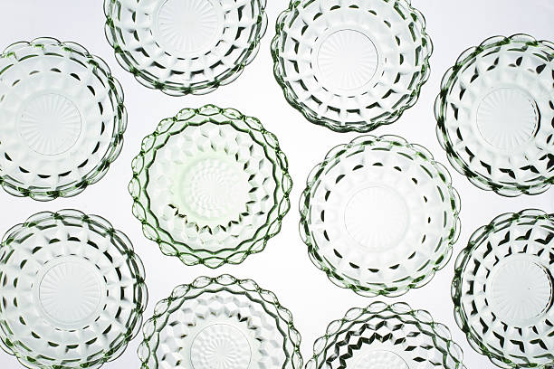 Green Depression glass bowls, back lit, shot from above to form an abstract pattern.