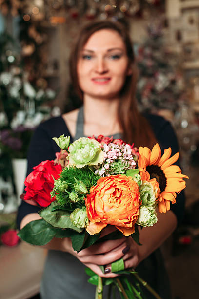 istock Florist hands holding bouquet flowers closeup. 637575732